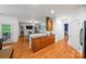 Open kitchen flowing into the living room, featuring oak cabinets and hardwood floors at 10434 Blackstock Rd, Huntersville, NC 28078