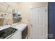Laundry room with shelving and a modern washer and dryer set at 10434 Blackstock Rd, Huntersville, NC 28078
