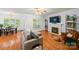 Cozy living room featuring a fireplace, hardwood flooring, and neutral-toned furniture at 10434 Blackstock Rd, Huntersville, NC 28078