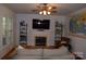 Cozy living room with fireplace and bright windows, perfect for relaxing at 10434 Blackstock Rd, Huntersville, NC 28078