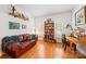 Inviting living room features hardwood floors, a comfortable leather sofa, and a built-in bookshelf at 10434 Blackstock Rd, Huntersville, NC 28078
