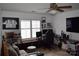 This living room features a ceiling fan, a mounted tv, and a gray couch at 10434 Blackstock Rd, Huntersville, NC 28078