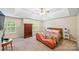 Bright main bedroom features trey ceiling, sunny windows, decorative bed, and warm colors at 10434 Blackstock Rd, Huntersville, NC 28078