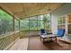 Relaxing screened-in porch with wood paneled ceilings, comfortable seating and views of the landscape at 10434 Blackstock Rd, Huntersville, NC 28078