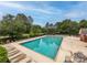 Large inground pool, with blue water, set in a green space with lounging furniture at 10434 Blackstock Rd, Huntersville, NC 28078