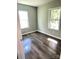 Sun-drenched bedroom features updated flooring and modern windows, offering a cozy retreat at 1052 S Grove Street Ext, Lincolnton, NC 28092