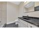 Well-lit bathroom with a toilet, sleek vanity, black countertop, and a modern black faucet at 1141 Harper Lee Dr, Newton, NC 28658