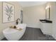 This primary bathroom features a soaking tub with views of the backyard and a granite-topped vanity at 1141 Harper Lee Dr, Newton, NC 28658
