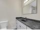 Modern bathroom featuring a black countertop, undermount sink, and a stylish mirror at 1141 Harper Lee Dr, Newton, NC 28658