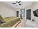 Inviting bedroom featuring a large window, ceiling fan, and a comfortable bed with an olive comforter at 1141 Harper Lee Dr, Newton, NC 28658