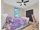 Bright bedroom with a fluffy bed, large window overlooking a field, and a fan at 1141 Harper Lee Dr, Newton, NC 28658