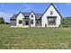 Charming two story home with modern design elements, lush lawn, and professional landscaping at 1141 Harper Lee Dr, Newton, NC 28658