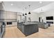 The kitchen area features an open floor plan with modern appliances and an oversized center island with seating at 1141 Harper Lee Dr, Newton, NC 28658