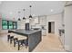 This spacious kitchen features light wood floors and a large center island with bar stool seating at 1141 Harper Lee Dr, Newton, NC 28658