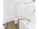 Clean, white bathroom features modern fixtures, wood-look flooring, and a well-lit vanity for a fresh feel at 120 Hepler Rd, Taylorsville, NC 28681