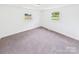 Spacious bedroom with neutral tones, carpet flooring, and windows offering ample natural light, creating a tranquil retreat at 120 Hepler Rd, Taylorsville, NC 28681