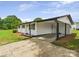 Home featuring a covered carport, with manicured mulch at 120 Hepler Rd, Taylorsville, NC 28681