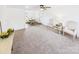 Bright living room with plush carpet, neutral walls, and dining area in background, offering a cozy atmosphere at 120 Hepler Rd, Taylorsville, NC 28681