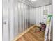 Utility room with durable wall panels, wood-look floors, and equipped with tool storage and workbench at 120 Hepler Rd, Taylorsville, NC 28681