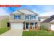 Charming two-story home featuring stone accents, a two-car garage, and a well-manicured lawn at 1340 Secrest Commons Dr, Monroe, NC 28112