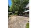 Outdoor patio area with mature trees, a screened-in porch, and a view of the expansive backyard at 13416 Four Oaks Ln, Matthews, NC 28105