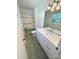 Bright bathroom featuring a modern vanity, tiled floors, and a shower with grab bars at 13416 Four Oaks Ln, Matthews, NC 28105