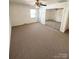 Spacious bedroom with carpet floors, ceiling fan, and mirrored closet doors at 13416 Four Oaks Ln, Matthews, NC 28105