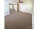 Spacious bedroom with carpet floors, ceiling fan, and mirrored closet doors at 13416 Four Oaks Ln, Matthews, NC 28105