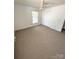 Bedroom featuring neutral carpet, a closet, and a window at 13416 Four Oaks Ln, Matthews, NC 28105