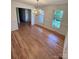 Dining room with hardwood floors, chandelier, and ample natural light at 13416 Four Oaks Ln, Matthews, NC 28105