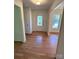 Inviting entryway with decorative glass door and hardwood flooring at 13416 Four Oaks Ln, Matthews, NC 28105