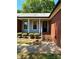 Inviting front entrance with brick steps, gray siding, white columns, and well-maintained landscaping at 13416 Four Oaks Ln, Matthews, NC 28105