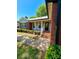 Charming home featuring a brick facade, light gray siding, and a welcoming front entrance with brick steps at 13416 Four Oaks Ln, Matthews, NC 28105
