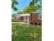 Quaint brick home featuring traditional architecture with shuttered windows and manicured front yard at 13416 Four Oaks Ln, Matthews, NC 28105