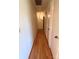 Long hallway featuring hardwood floors and neutral paint at 13416 Four Oaks Ln, Matthews, NC 28105