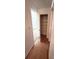 Hallway with hardwood flooring, closet, and a bedroom in the background at 13416 Four Oaks Ln, Matthews, NC 28105