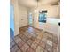 Bright kitchen featuring tile floors, white cabinets, and natural light, with an adjacent doorway and window at 13416 Four Oaks Ln, Matthews, NC 28105