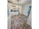 Bright kitchen featuring tile floors, white cabinets, and stainless appliances with a breakfast bar and adjacent doorway at 13416 Four Oaks Ln, Matthews, NC 28105
