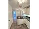 Bright kitchen featuring tile floors, white cabinets, black counters, stainless appliances, and an adjacent doorway at 13416 Four Oaks Ln, Matthews, NC 28105