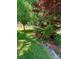 Landscaped yard featuring a mix of flowering trees, bushes, ground cover, and a wooden fence at 13416 Four Oaks Ln, Matthews, NC 28105
