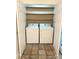 Practical laundry closet with washer, dryer and shelving for storage at 13416 Four Oaks Ln, Matthews, NC 28105