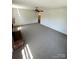 Large living room featuring a brick fireplace and plush carpeting at 13416 Four Oaks Ln, Matthews, NC 28105