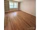 Hardwood floors, built-in bookshelves, and natural light enhance the living room's charm at 13416 Four Oaks Ln, Matthews, NC 28105