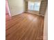 Elegant living room with gleaming hardwood floors and stylish built-in bookshelves at 13416 Four Oaks Ln, Matthews, NC 28105