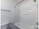 Clean white bathroom featuring a tub shower with chrome fixtures and matching towel rack at 1348 Green Oaks Ln # L, Charlotte, NC 28205