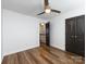 Bedroom with wood flooring, ceiling fan, closet and access to hallway at 1348 Green Oaks Ln # L, Charlotte, NC 28205