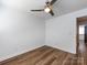 Bedroom with wood flooring, ceiling fan, and bright windows at 1348 Green Oaks Ln # L, Charlotte, NC 28205