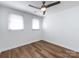 Bedroom with wood flooring, ceiling fan, and bright windows at 1348 Green Oaks Ln # L, Charlotte, NC 28205