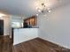 Open-concept dining area features modern lighting, hardwood floors, and seamless flow to the kitchen at 1348 Green Oaks Ln # L, Charlotte, NC 28205
