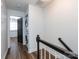 Upstairs hallway area with laundry and bedroom access and wood floors at 1348 Green Oaks Ln # L, Charlotte, NC 28205
